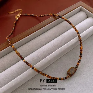 Tiger eye beaded necklace with a rectangular stone pendant and gold lobster clasp