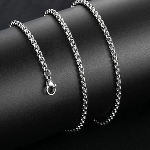 Detail of the high-quality silver lobster clasp and textured metal chain on black background