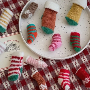Close-up of mini knitted Christmas stockings in various colors for DIY holiday decor