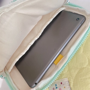 Internal view of quilted yellow tablet sleeve showing storage capacity for 11 inch device
