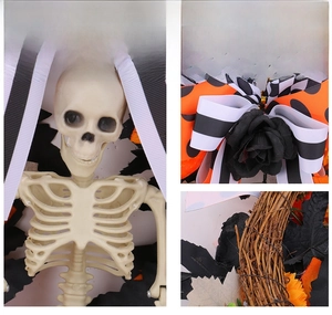Macro view of Halloween skeleton wreath with black roses and orange checkered ribbons