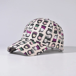 Neutral baseball cap in beige with all-over colorful cartoon face print patterns