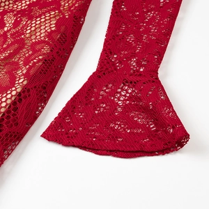 Detailed close-up of red floral lace fabric and flared sleeve design on the dress