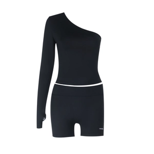 Detail of black off-shoulder workout set featuring one sleeve with thumbhole and FASHION text