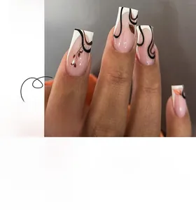 Detail of long coffin press-on nails with French tips and black leaf swirl patterns