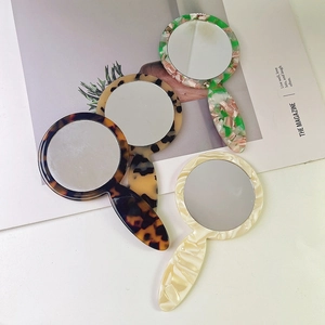 Portable acetate hand mirrors in tortoiseshell and marble patterns for daily makeup