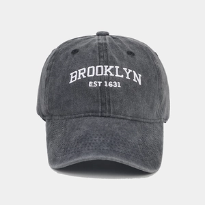 Detailed embroidery on a dark grey washed cotton baseball cap featuring Brooklyn EST 1631