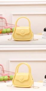 Detailed view of bright yellow mini PVC jelly bag with golden chain and curved handle