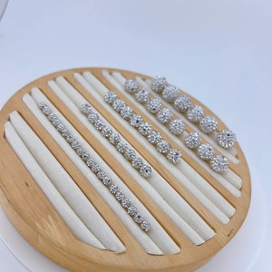 Macro view of silver cubic zirconia spacer beads in various sizes on a wooden tray
