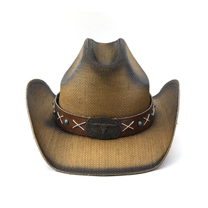 Detail of straw cowboy hat featuring a leather band with turquoise beads and bull skull buckle