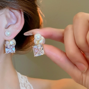 Detail of 18k gold plated earring with square zircon and dual-sided pearl drops