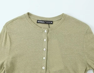 Close-up of linen blend knit t-shirt with round neck and white button detailing