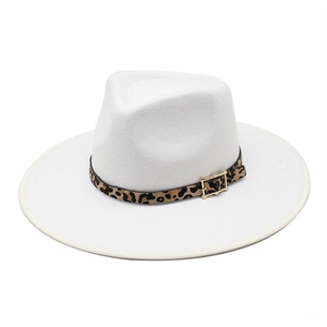 Close-up of white wide brim fedora hat featuring leopard print band and golden buckle