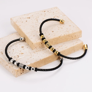 Braided leather bracelets in gold and silver finish with zircon charms on stone slabs