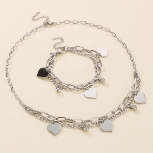 Silver layered necklace and bracelet set with heart pendants and beads in stainless steel
