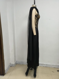 Detail of black lace bodice with sheer mesh shawl and long satin evening gown skirt