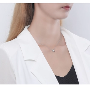 Close-up of elegant S925 silver necklace with single zircon pendant on model neck