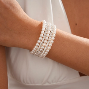 Close-up of five-layer multilayer bracelet with white pearls and sparkling rhinestone accents