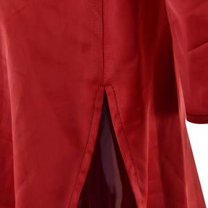 Detailed close-up of side slit design on a red satin dress with fine stitching details
