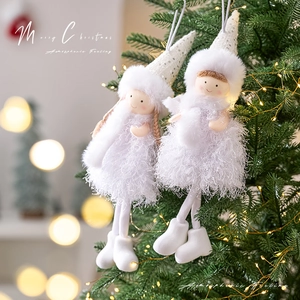 White Christmas angel ornaments on a lit tree, handmade plush hanging doll decorations