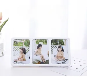 Close-up of minimalist white triple tabletop photo frame with vertical picture slots