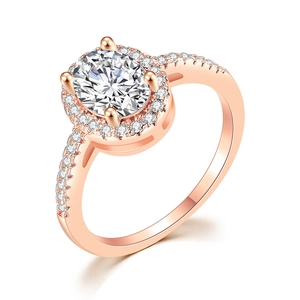 Detail of rose gold engagement ring with oval diamond and micro-pave halo setting