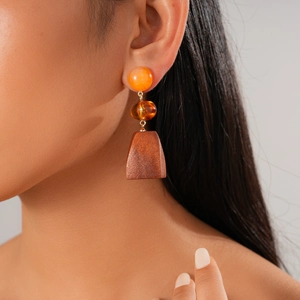 Detail view of Bohemian vintage drop earrings with resin beads and trapezoid wood pendant