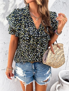 Close-up of floral print top featuring ruffled sleeves and elegant V-neck design