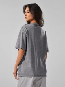 Detail of drop shoulder design and washed vintage texture on heavy cotton t-shirt