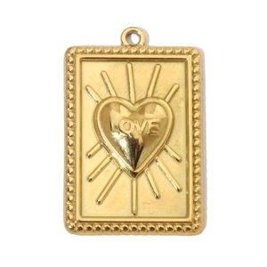 Macro shot of gold rectangle pendant featuring a sunburst love heart design