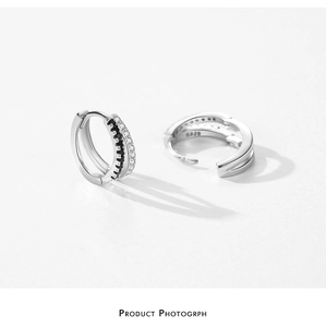 Detailed macro view of S925 sterling silver hoop earrings with black and white crystals