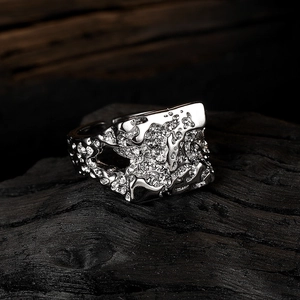 Irregular lava texture wide silver metal ring for women on dark charcoal background