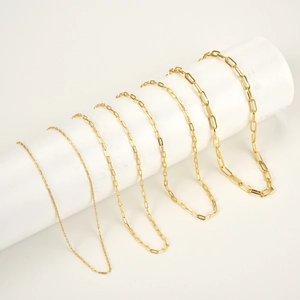 Classic gold paperclip chain necklaces in six varied link sizes shown on white pedestals