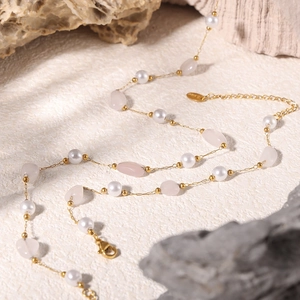 Elegant stainless steel necklace with white pearls and pink natural stones on a gold chain