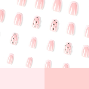 Light pink French press on nails with silver rhinestones scattered on a soft background