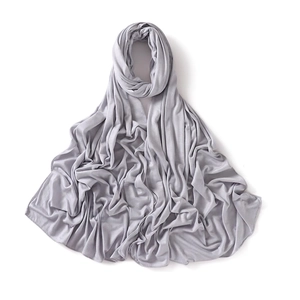 Detail of light grey jersey scarf featuring soft modal texture and fine hemmed edges