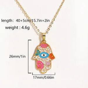 Detailed view of gold Hamsa Hand pendant with colorful enamel eye on O-link chain