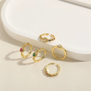 Set of five gold open rings featuring colorful zircon stones in various geometric designs