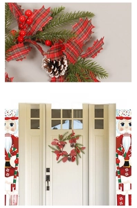 Detail of Christmas wreath with pine cones and berries hung on a white door