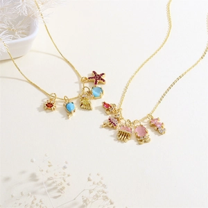 Creative gold ocean charm necklace featuring colorful sea life pendants and gemstones