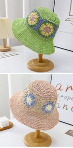 Detail of woven straw bucket hat featuring vibrant floral crochet patterns and wavy brim
