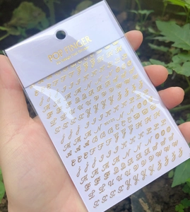 Detail of gold 3D Gothic alphabet nail art stickers in WG720 packaging