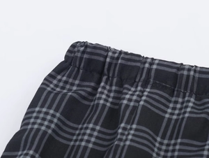 Detail of elastic waistband on casual black and grey plaid puff shorts for women