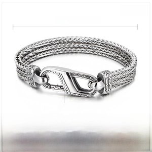 Macro shot of 220x10mm steel woven chain bracelet showing S-lock detail and texture