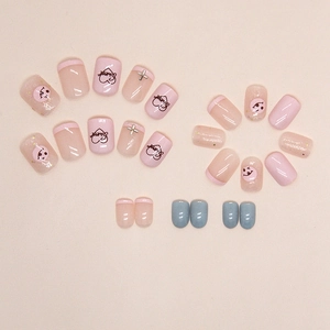 Pink sweet press-on nails with heart, smile face, and silver cross metallic charms