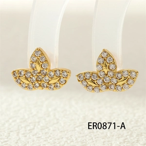 Macro shot of gold-plated clover earrings with white zircons on a display stand