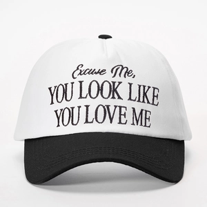Two-tone baseball cap in black and white with YOU LOOK LIKE YOU LOVE ME embroidery
