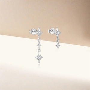 Macro detail of asymmetric S925 sterling silver star earrings with tassels and S925 hallmark