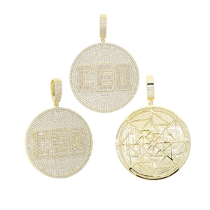Detailed view of gold shield pendants with CEO zircon stones and geometric hollow back