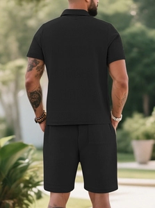 Close-up of black men's polo set showing intricate waffle knit texture and premium fabric